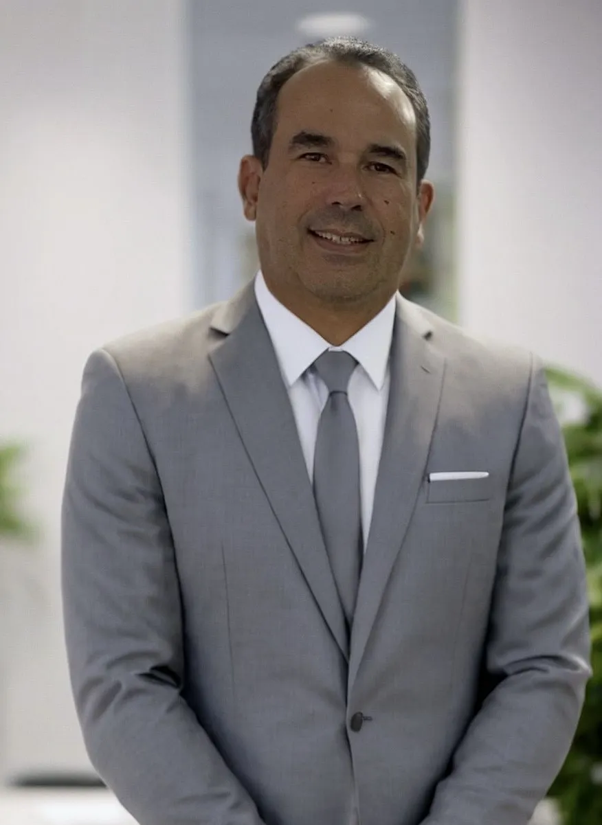 Luiz Monteiro, CPCON Managing Director Brazil - professional headshot in gray suit